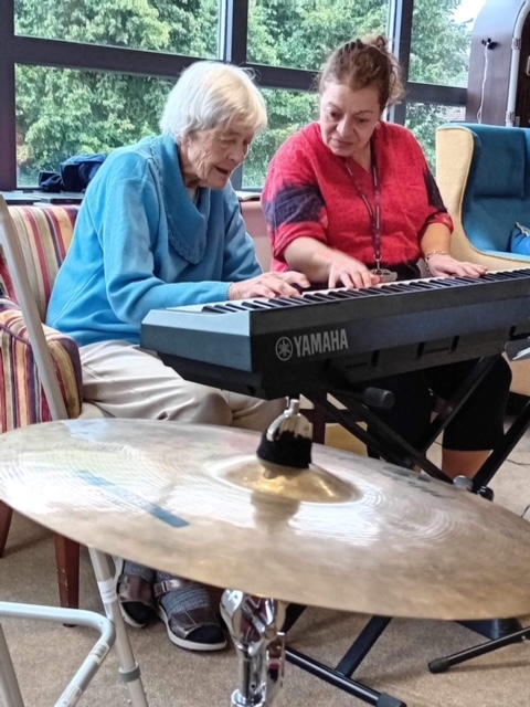 Residents playing an electronic keyboard