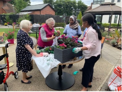 residents and staff gardening