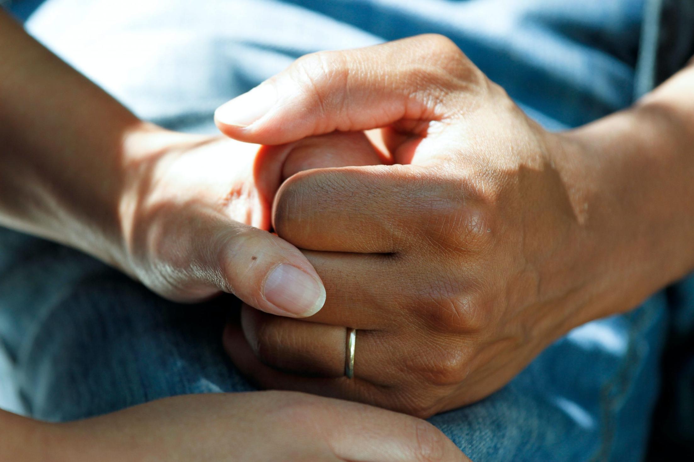 resident holding hands with carer