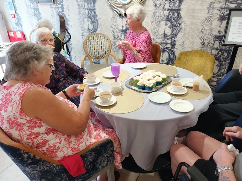 our residents sat around a table enjoying cupcakes