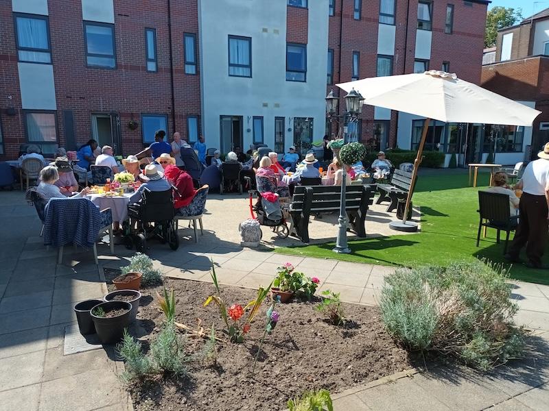 residents in the garden enjoying the bbq