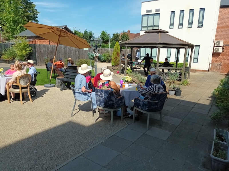 our residents watching people performing on the band stand