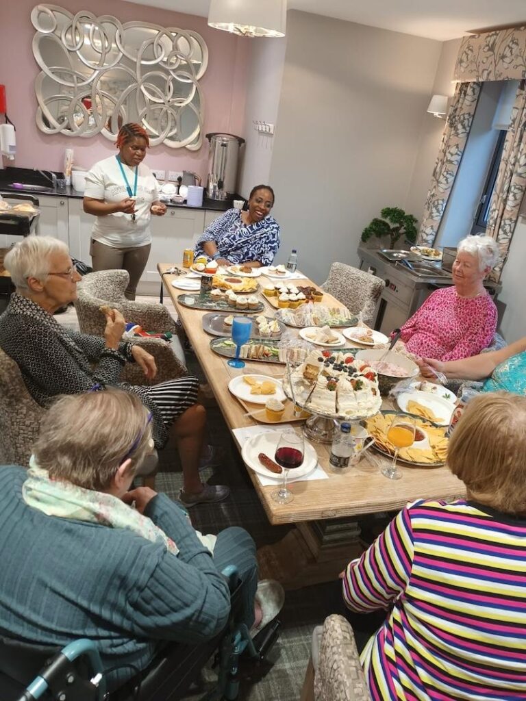 residents sat round the table enjoying lunch together