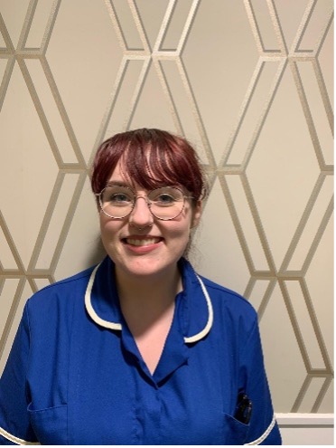 lady wearing glasses posing for staff photo