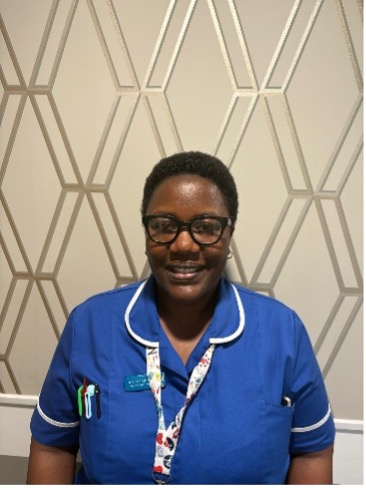 lady wearing glasses posing for staff photo