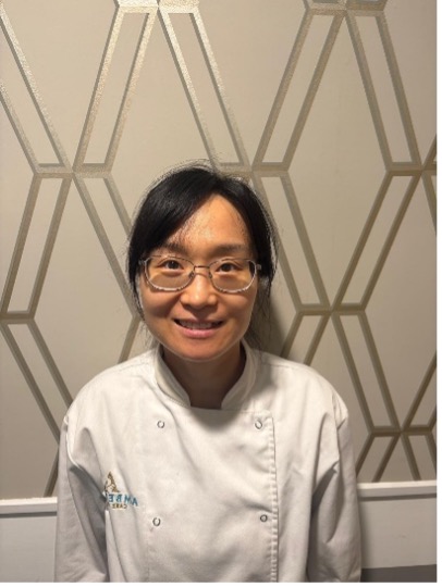 lady wearing glasses posing for staff photo