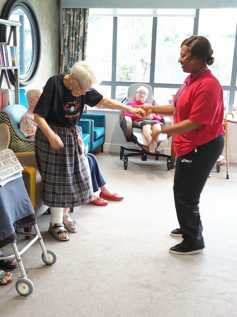 resident dancing with a carer