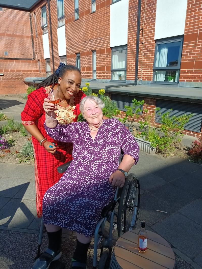 older lady in a wheelchair with the home manager
