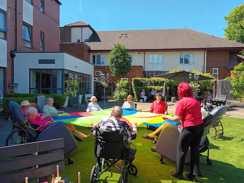 residents with a parachute in garden