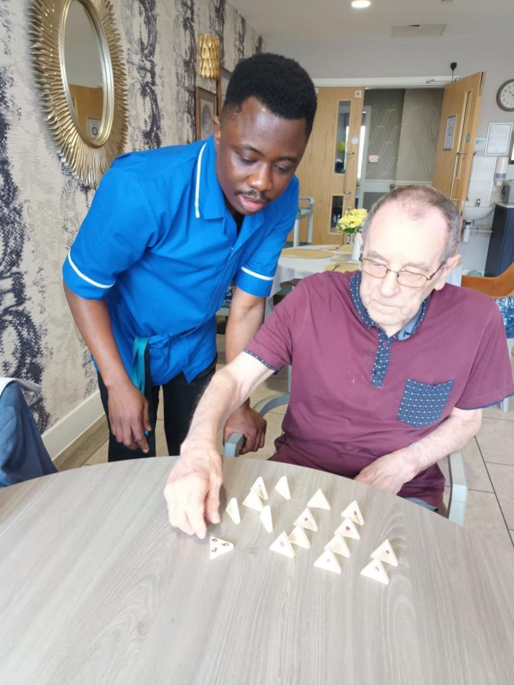 resident and carer playing a game