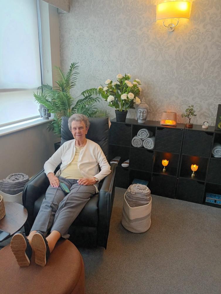 older lady sat with feet up