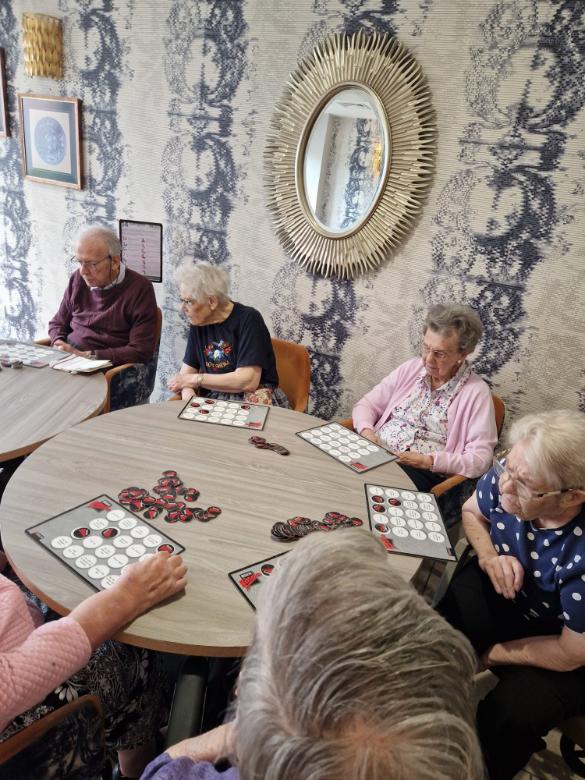 residents sat around a table playing games